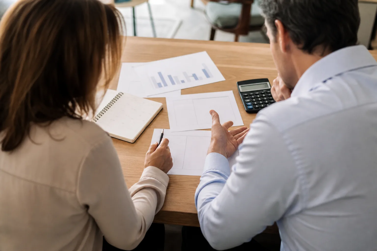 Business owners discussing what is a salary? with financial charts Business owners discussing what is a salary? with financial charts
