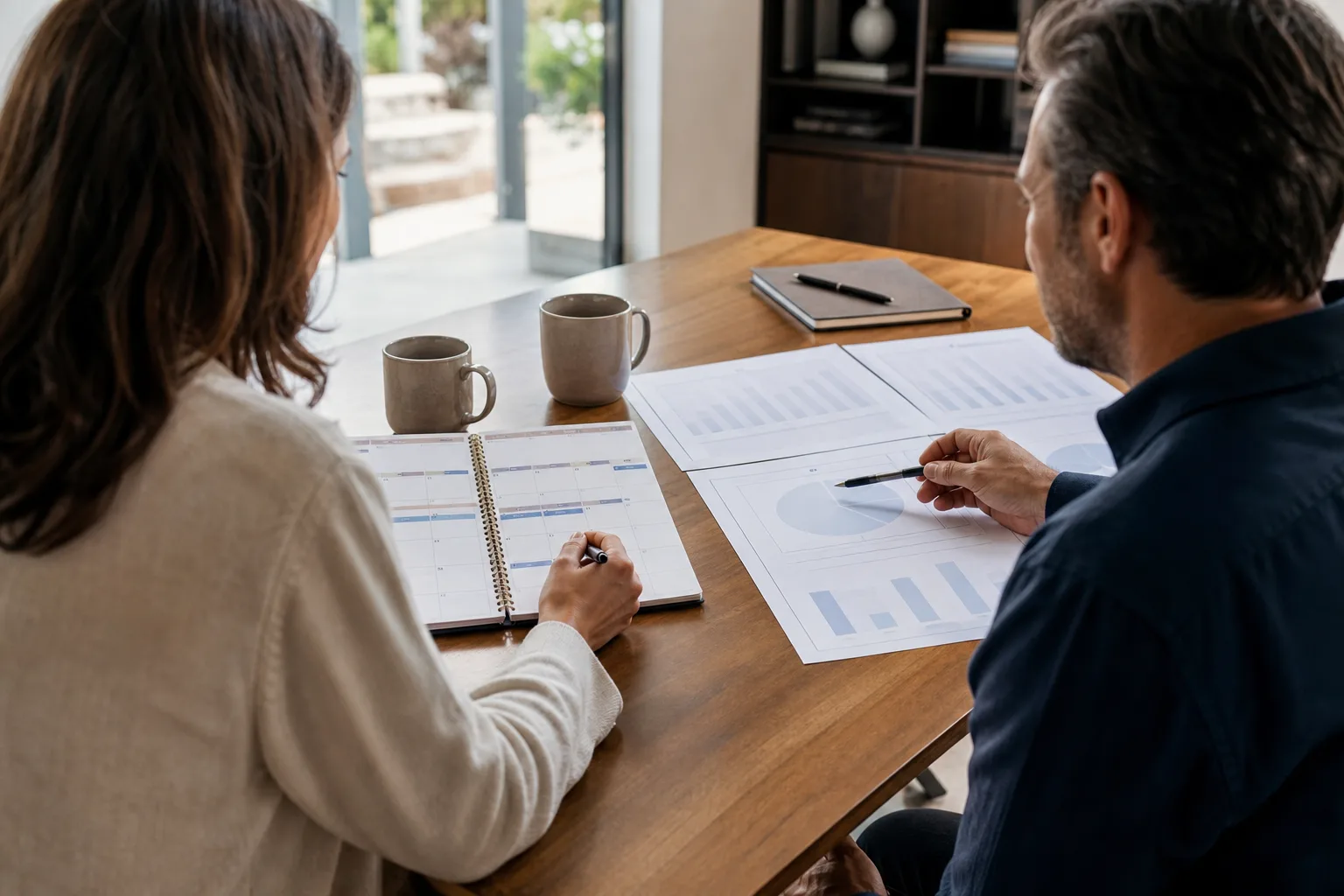 Business owners discussing the unique challenges business owners face with financial charts Business owners discussing the unique challenges business owners face with financial charts