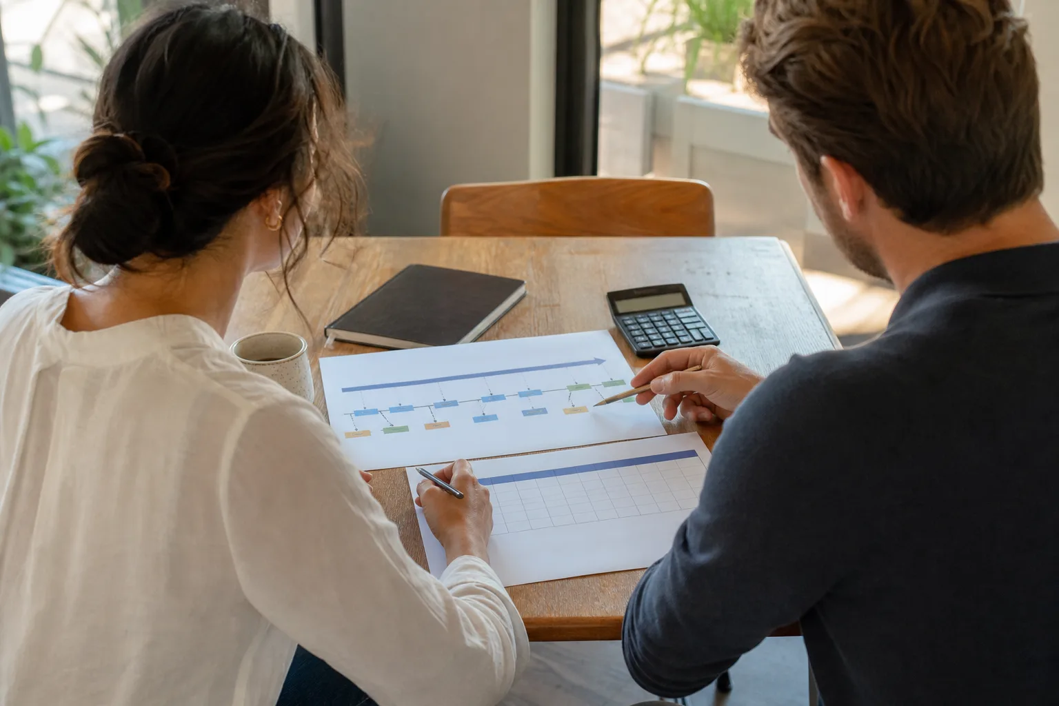 Business owners discussing why founder-led businesses need a dynamic view with financial charts