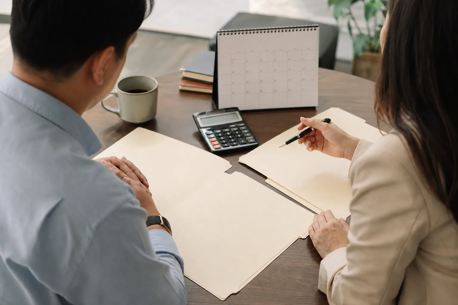 Business owners discussing the role of a fractional cfo in tax strategy with financial charts